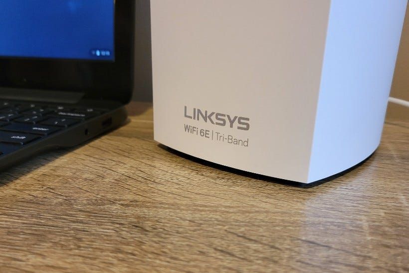 The Linksys logo with text pointing out it is a tri-band Wi-Fi 6E router
